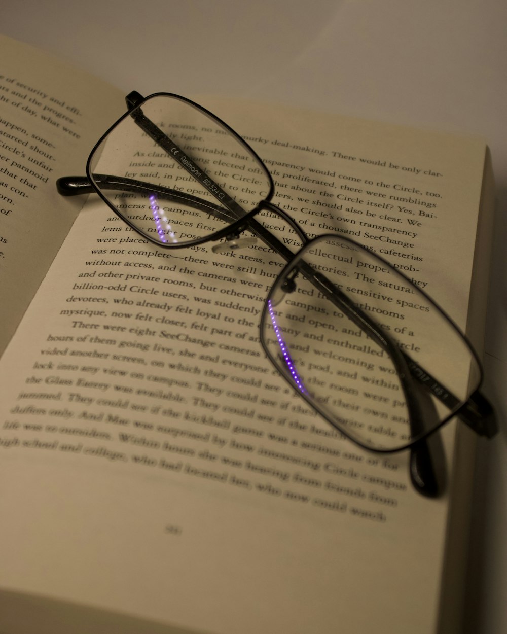 Glasses resting on an open book in warm evening light